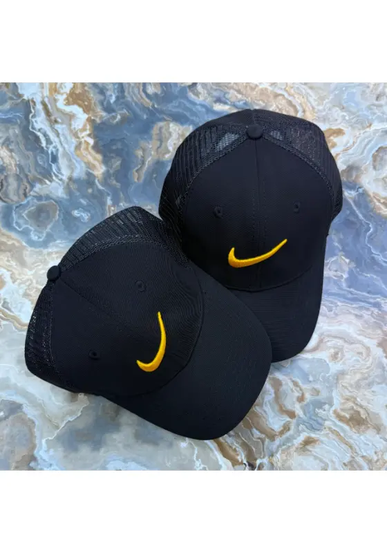 black Nike trucker cap with a yellow swoosh